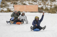 Visitors enjoy the snow at the Afriski ski resort near Butha-Buthe, Lesotho, Saturday July 30, 2022. While millions across Europe sweat through a summer of record-breaking heat, Afriski in the Maluti Mountains is Africa's only operating ski resort south of the equator. It draws people from neighboring South Africa and further afield by offering a unique experience to go skiing in southern Africa. (AP Photo/Jerome Delay)