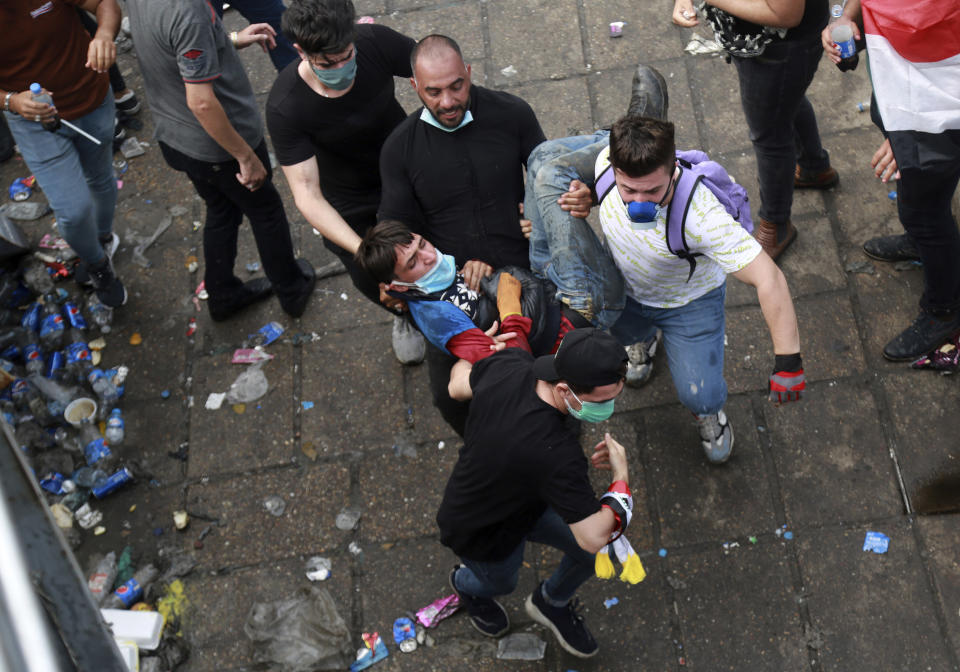 An injured protester is rushed to a hospital during a demonstration in Baghdad, Iraq, Monday, Oct. 28, 2019. Protests have resumed in Iraq after a wave of protests earlier this month were violently put down. (AP Photo/Hadi Mizban)