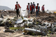 FILE PHOTO: Ethiopian Red Cross workers carry a body bag with the remains of Ethiopian Airlines Flight ET 302 plane crash victims at the scene of a plane crash, near the town of Bishoftu, southeast of Addis Ababa, Ethiopia March 12, 2019. REUTERS/Baz Ratner