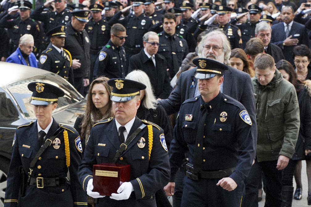Attendees at a funeral mass earlier this month for Texas police officer David Hofer. The patrolman is one of 16 officers to be fatally shot this year. (Photo: Mark Lennihan/AP)
