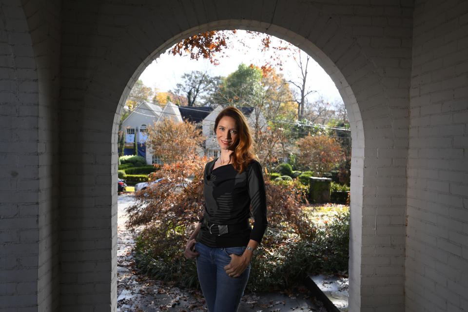 In this Nov. 27, 2019, photo, Georgia Tech professor Kim Cobb poses for a photo at her home in Atlanta. Some climate scientists and activists, including Cobb, are limiting their flying, their consumption of meat and their overall carbon footprints to avoid adding to the global warming they study. (AP Photo/John Amis)