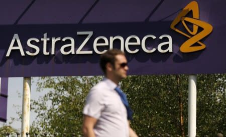 FILE PHOTO: A man walks past a sign at an AstraZeneca site in Macclesfield, central England May 19, 2014. REUTERS/Phil Noble/File Photo