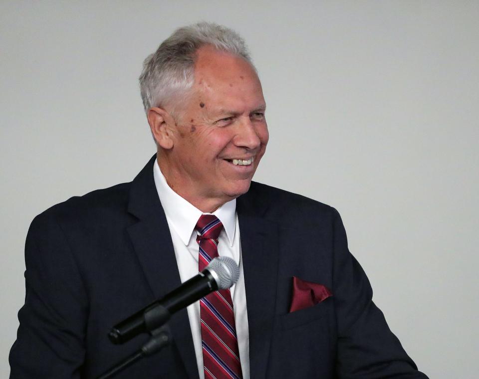 Mike Meneer, Central-Hower basketball coach from 1983-1990, gives his acceptance speech during the 2023 Akron Public Schools Athletics Hall of Fame induction ceremony at House Three Thirty, Saturday, Oct. 21, 2023, in Akron, Ohio.