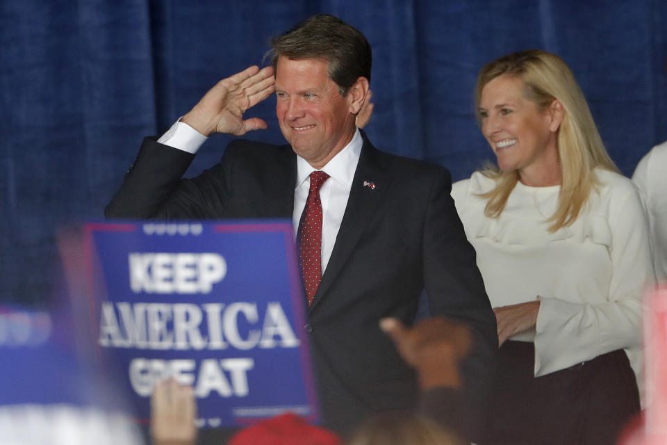 Republican candidate for Georgia Governor Brian Kemp reacts as he and his wife Marty step on stage for a rally Sunday, Nov. 4, 2018, in Macon, Ga. (AP Photo/John Bazemore)