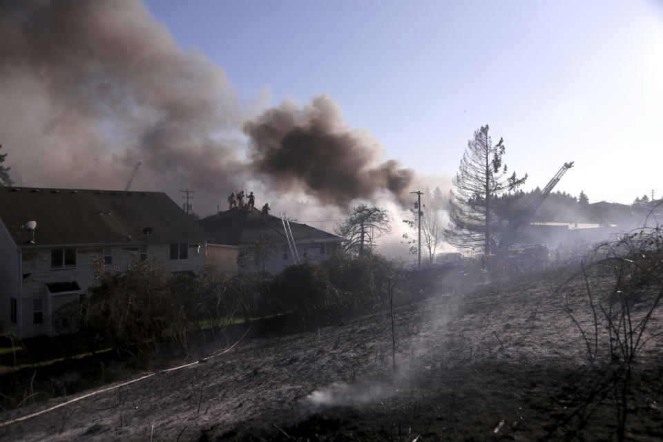 A blaze Monday, Aug. 26, 2019 in Northeast Portland that started as a grass fire has spread to several buildings near 85th Avenue and Siskiyou Street. (Beth Nakamura/The Oregonian via AP)