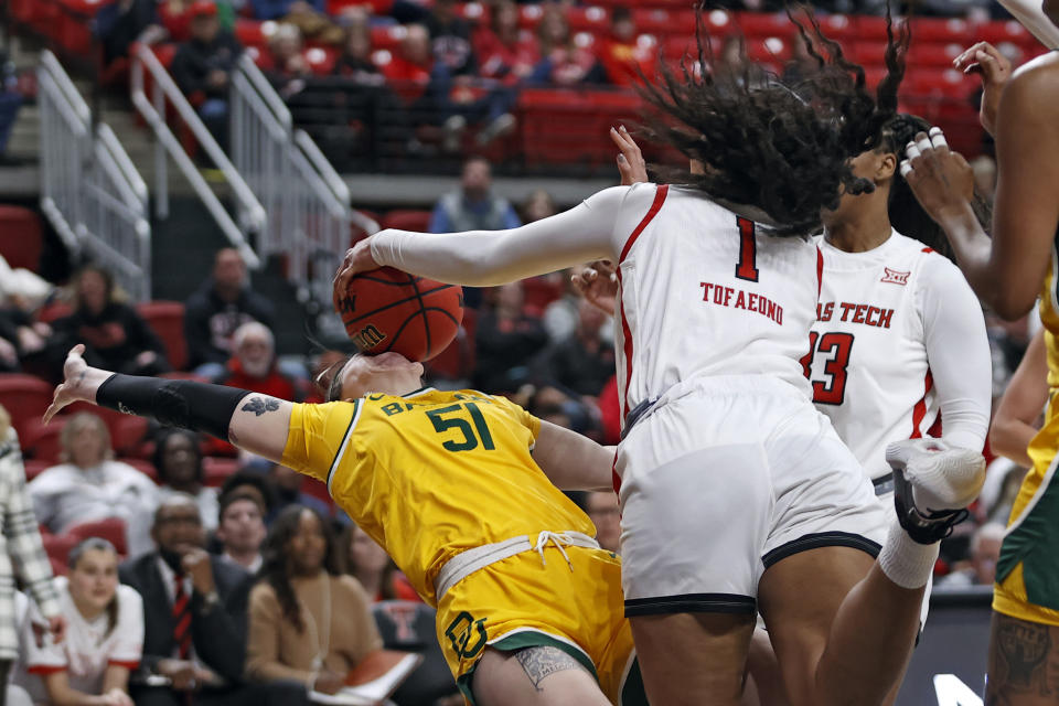 Texas Tech's Ella Tofaeono (1) fouls Baylor's Caitlin Bickle (51) by hitting the ball in her face during the first half of an NCAA college basketball game on Wednesday, Jan. 26, 2022, in Lubbock, Texas. (AP Photo/Brad Tollefson)