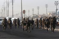 Iraqi security forces are seen during ongoing anti-government protests in Basra