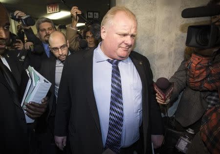 Toronto Mayor Rob Ford walks through a busy media scrum as he walks to his office during a break in a Capital and Operating Budgets meeting at City Hall in Toronto, January 22, 2014. REUTERS/Mark Blinch