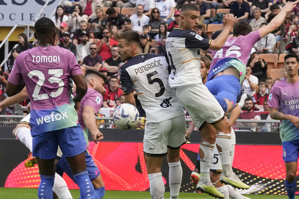 AC Milan's Olivier Giroud, second from left, scores his side's second goal during the Serie A soccer match between AC Milan and Lecce at the San Siro stadium, in Milan, Italy, Saturday, April 6, 2024. (AP Photo/Antonio Calanni)