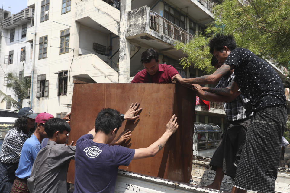 State railway employees load furniture in to a truck after being evicted from their home Saturday, March 20, 2021, in Mandalay, Myanmar. State railway workers in Mandalay have been threatened with eviction to force them to end their support for the Civil Disobedience Movement (CDM) against military rule. (AP Photo)