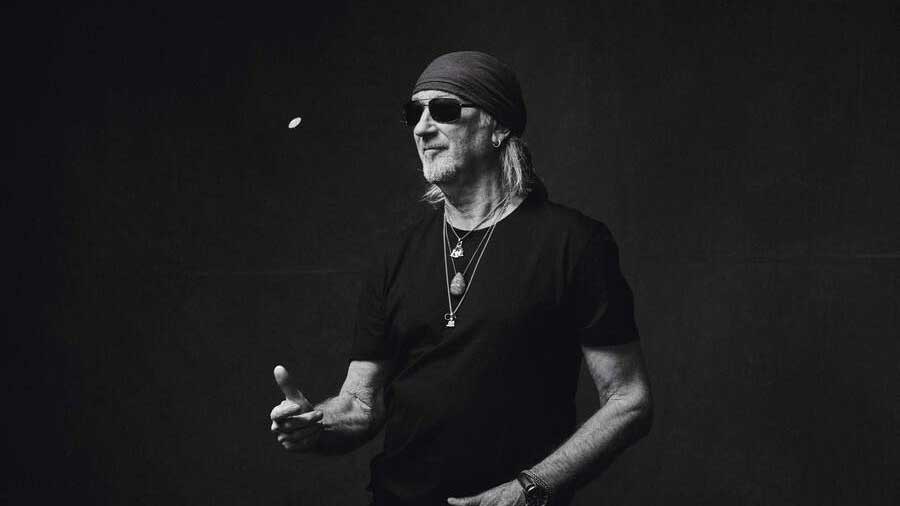  Roger Glover flipping a coin. 