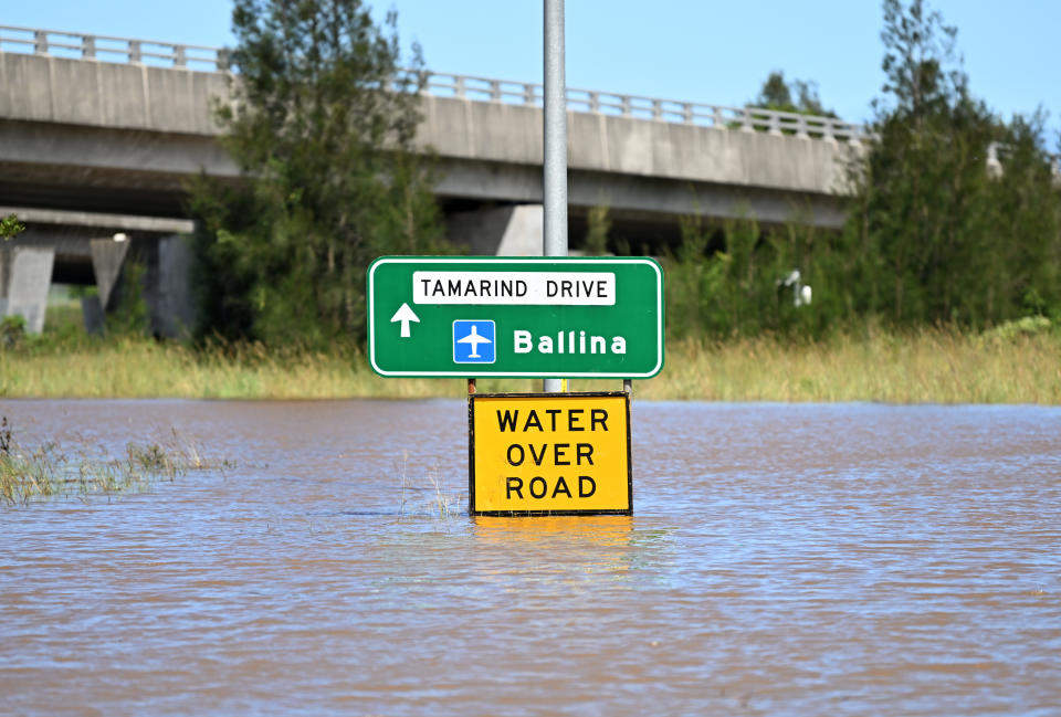 CUMBALUM, AUSTRALIA - MARCH 02: A road sign showing directions to Ballina is surrounded by floodwater on March 02, 2022 in Cumbalum, Northern NSW, Australia. Several northern New South Wales towns have been forced to evacuate as Australia faces unprecedented storms and the worst flooding in a decade. (Photo by Dan Peled/Getty Images)