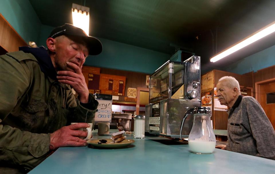 Two people at the Silver Crest Donut Shop Restaurant and Bar in San Francisco.