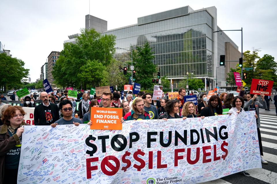 Protesters march outside of the World Bank's spring meetings Friday in Washington, DC.