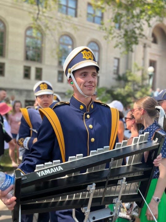 Luke Foster of Monroe, a member of the University of Notre Dame marching band, prepares for a gameday march-out to the stadium. He is shown playing the marching bells.