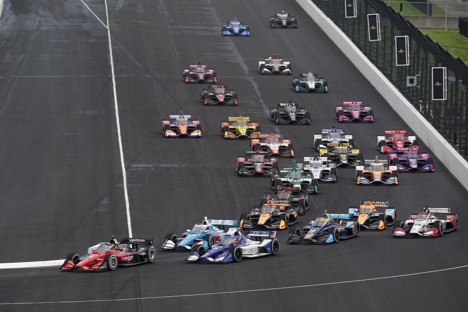 Will Power, of Australia, leads the field into turn one for the IndyCar auto race at Indianapolis Motor Speedway, Saturday, May 14, 2022, in Indianapolis. (AP Photo/Darron Cummings)