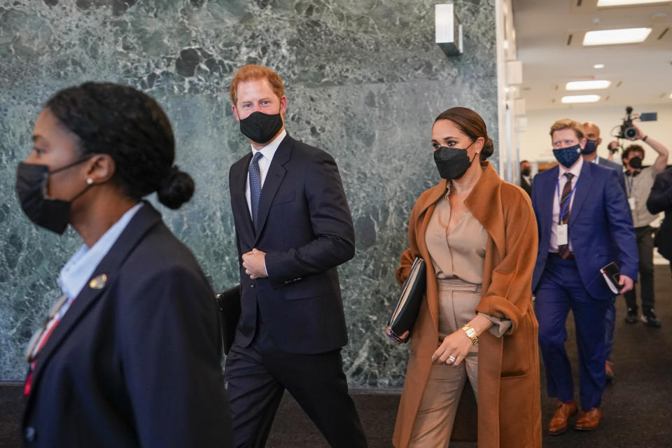 Prince Harry and Meghan, the Duke and Duchess of Sussex are escorted as they leave the United Nations headquarters after a visit during 76th session of the United Nations General Assembly, Saturday, Sept. 25, 2021. (AP Photo/Mary Altaffer)