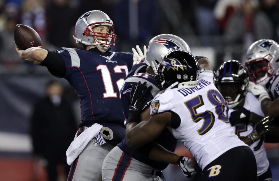 New England Patriots quarterback Tom Brady (12) throws a touchdown pass to Chris Hogan under pressure from Baltimore Ravens linebacker Elvis Dumervil (58) during the fourth quarter of an NFL football game, Monday, Dec. 12, 2016, in Foxborough, Mass. (AP Photo/Charles Krupa)