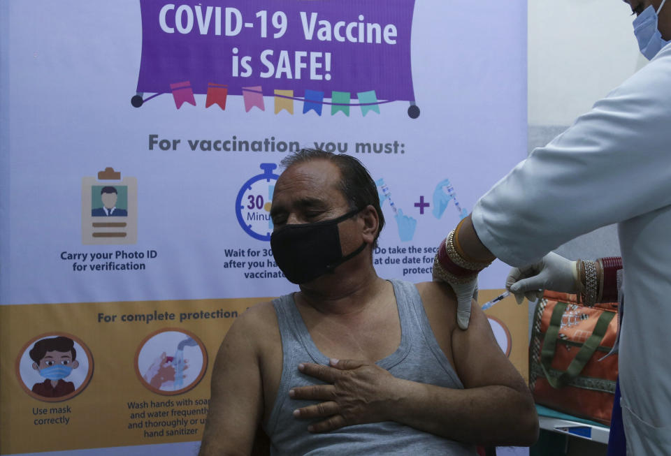 A man receives COVISHIELD vaccine at the Government Medical College hospital in Jammu, India, Monday, March 1, 2021. India is expanding its COVID-19 vaccination drive beyond health care and front-line workers, offering the shots to older people and those with medical conditions that put them at risk. (AP Photo/Channi Anand)