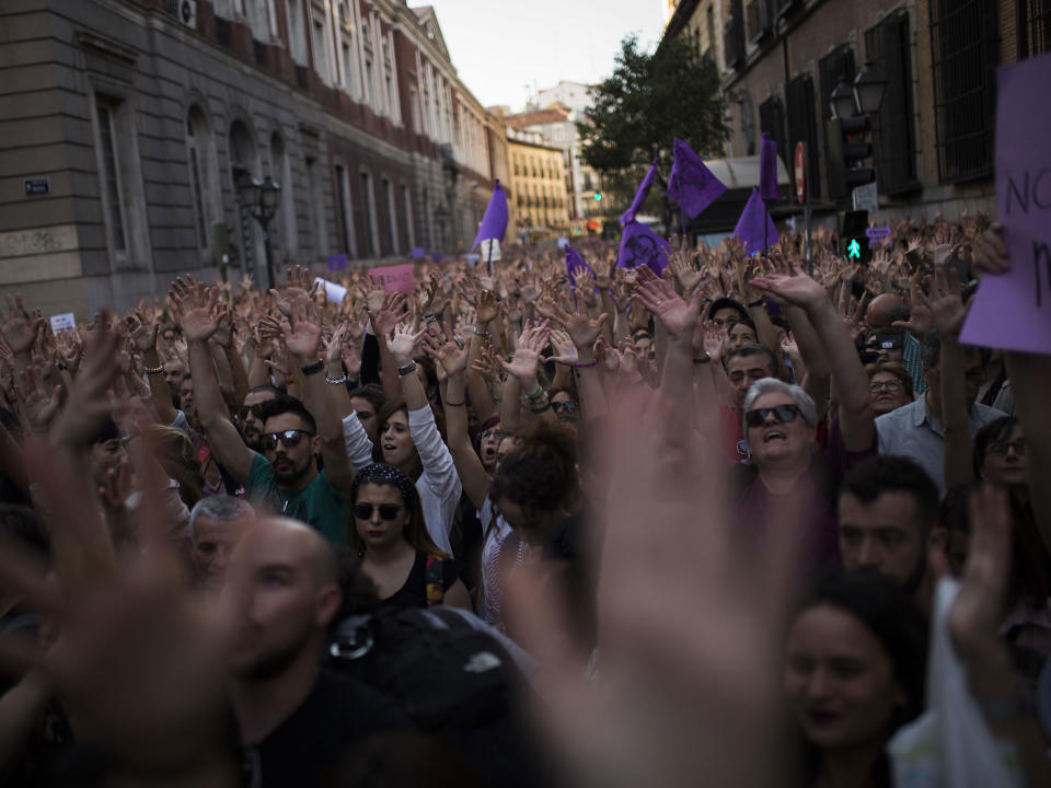 People lift their arms as they shout slogans during a protest outside the Justice Ministry in Madrid: AP Photo/Francisco Seco