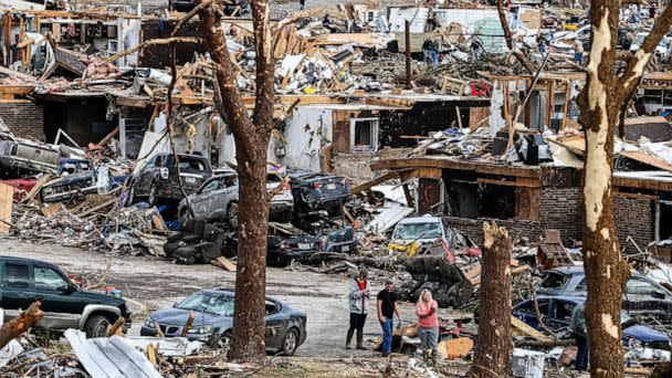 PHOTO: People clear their destroyed homes in Dawson Springs, Ky., Dec. 14, 2021, four days after tornadoes hit the area. (Chandan Khanna/AFP via Getty Images)