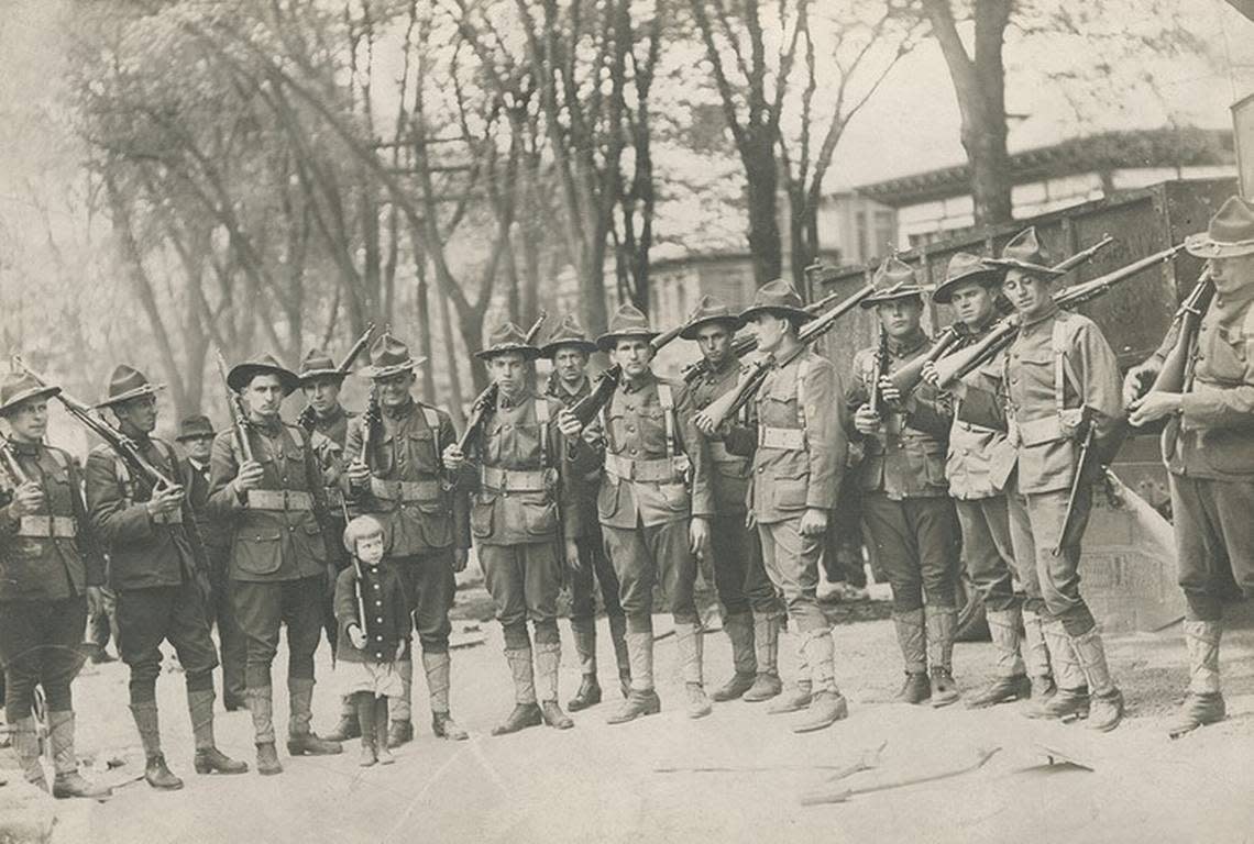Among the exhibits in “The Little War” at the National WWI Museum and Memorial is a photograph of a young girl holding a toy rifle as she poses with American soldiers.