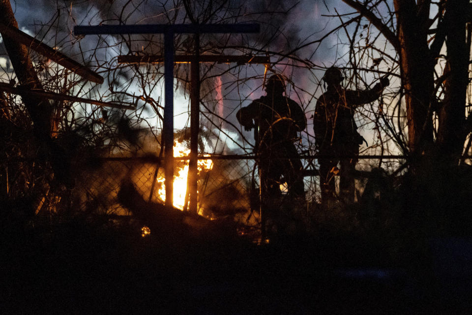 Emergency personnel are shown at the scene of a fire and explosion at a home in Flint, Mich., Monday night, Nov. 22, 2021. Three people were missing following the fire and explosion, authorities said. (Isaac RitcheyThe Flint Journal via AP)
