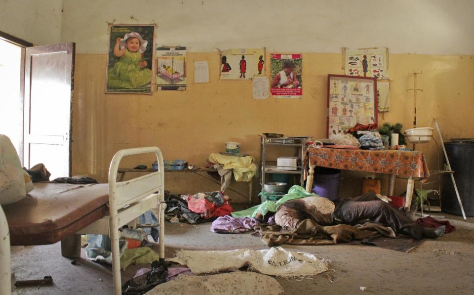 In this photo taken Wednesday, Feb. 26, 2014, the body of a dead civilian remains in a room in the hospital in Malakal, South Sudan. A week ago forces loyal to former vice president Riek Machar retook Malakal in a bloody assault that forced the government army to make what it labeled a tactical withdrawal, while Human Rights Watch said Thursday that both government and rebel forces are responsible for serious abuses that may amount to war crimes for atrocities committed in Malakal and Bentiu, another capital of an oil-producing state, despite a cease-fire signed in January. (AP Photo/Ilya Gridneff)