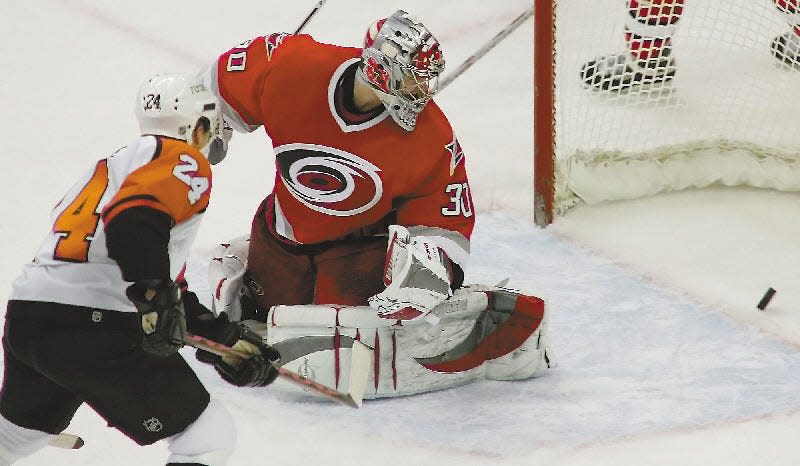 Former Carolina Hurricanes Sami Kapanen, of Finland, shoots the winning shot for the Philadelphia Flyers past Carolina Hurricanes' goal tender Cam Ward (30) during overtime of this NHL hockey game, Thursday, Dec 29, 2005, at the RBC Center in Raleigh, NC. Flyers won 4-3.