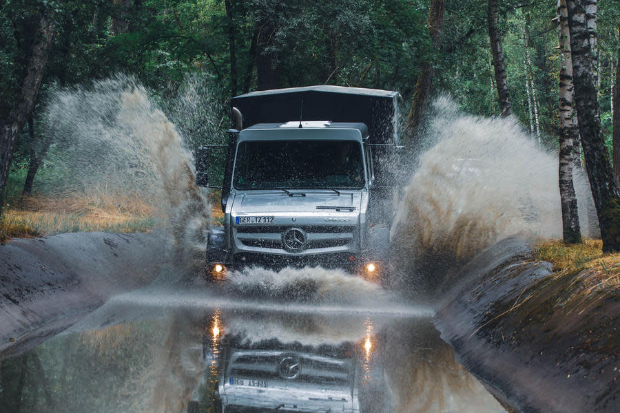 Unimog driving through water splash – front