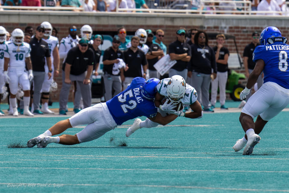 Sep 17, 2022; Conway, South Carolina, USA; Coastal Carolina Chanticleers running back Reese White (2) is tackled by Buffalo Bulls linebacker Shaun Dolac (52) in the first quarter at Brooks Stadium. Mandatory Credit: David Yeazell-USA TODAY Sports