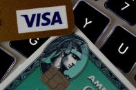 An American Express and a Visa credit cards are seen on a computer keyboard in this picture illustration taken September 6, 2017. REUTERS/Philippe Wojazer/Illustration/File Photo