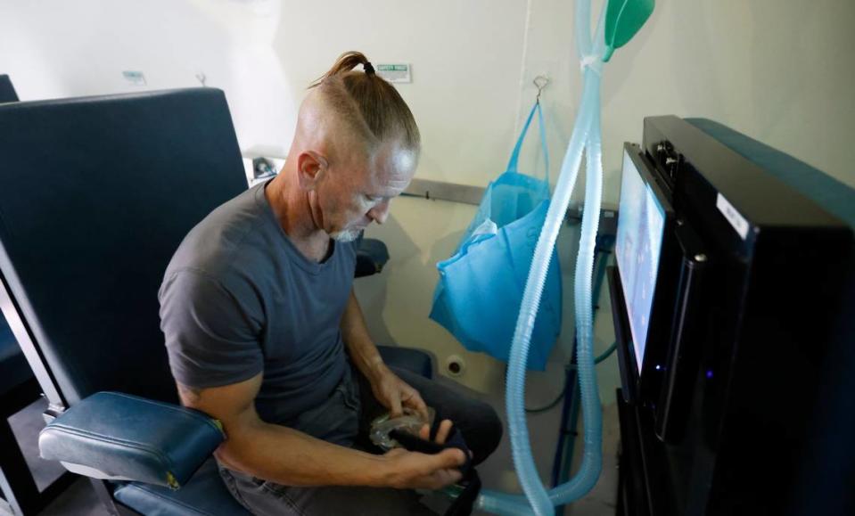 Simon LeMay, a Marine Corps veteran, prepares for a hyperbaric oxygen therapy session at Extivita in Durham, N.C., on Sept. 22, 2022. LeMay said he came back from his military deployments broken and suicidal and the hyperbaric oxygen treatments “has absolutely changed my life.”