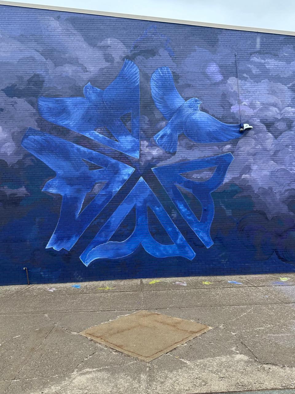 The mural of the front wall of the Edgerton R-Center now welcomes visitors with a unique take on the Rochester logo and birds taking flight on a stunning shades of blues and grays.