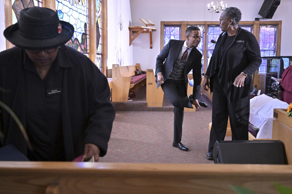 The Rev. Brandon Thomas Crowley, center, prepares for Sunday service with church staff members at Myrtle Baptist Church in Newton, Mass., on Sunday, May 5, 2024. (AP Photo/Josh Reynolds)