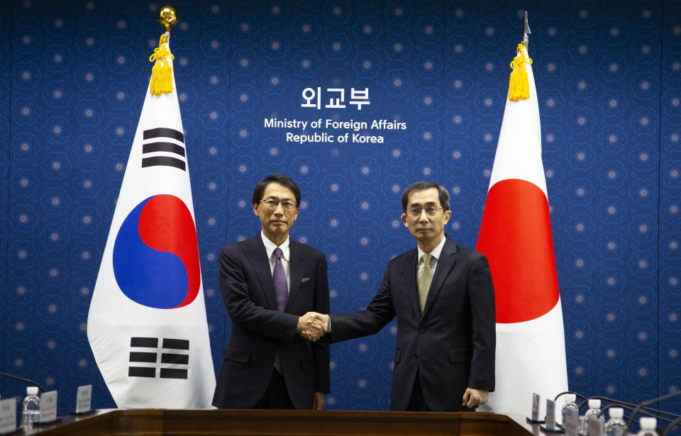 South Korean Kang Jae-kwon, right, Ministry of Foreign Affairs Deputy Minister for Economic Affairs, shakes hands with Japanese counterpart Keiichi Ono, left, Senior Deputy Minister for Foreign Affairs prior their meeting at the ministry of foreign affairs in Seoul, South Korea. Thursday, Dec. 21, 2023. (Jeon Heon-Kyun/Pool Photo via AP)