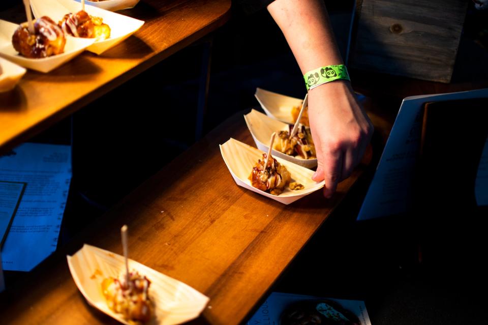 The USA TODAY Wine & Food Experience is hosted in cities across the U.S. each year. Pictured: A vendor adjusts samples of monkey bread at the Scottsdale, Arizona Wine and Food Experience on Nov. 2, 2019.