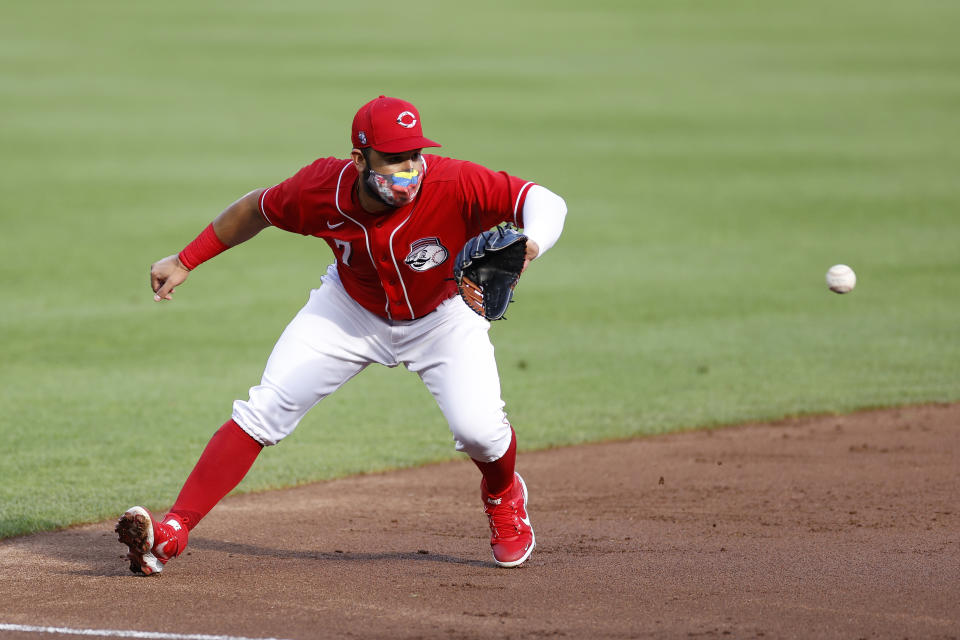 CINCINNATI, OH - JULY 21: Eugenio Suarez #7 of the Cincinnati Reds fields a ground ball while wearing his facemask in the first inning of an exhibition game against the Detroit Tigers at Great American Ball Park on July 21, 2020 in Cincinnati, Ohio. (Photo by Joe Robbins/Getty Images)