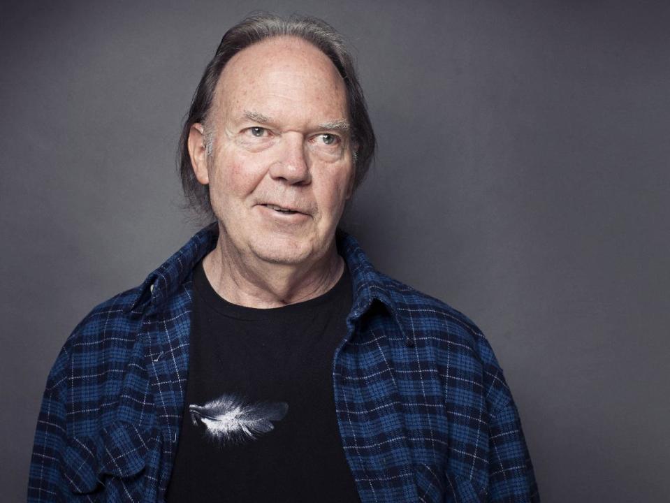 FILE - This Sept. 27, 2012 file photo shows singer-songwriter Neil Young posing for a portrait at The Carlyle hotel in New York. Two-time Grammy winner Young is honored on Tuesday, Jan. 21, 2014 for his commitment to excellence and ongoing support for the art and craft of recorded music, by the producers and engineers wing of the recording academy ahead of the Grammys ceremony. The 56th annual Grammy Awards are held Sunday, Jan. 26, 2014 at the Staples Center in Los Angeles. (Photo by Victoria Will/Invision/AP, File)