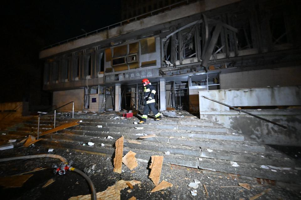 A firefighter walks in front of the National Scientific Center's Institute of Metrology following a Russian drone attack in Kharkiv on Dec. 31, 2023.