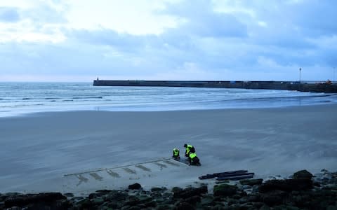 Volunteers working on Pages of the Sea this morning  - Credit: Reuters