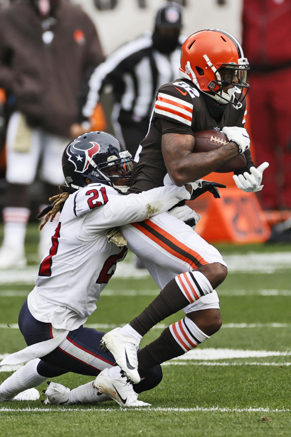 Cleveland Browns wide receiver Rashard Higgins (82) is tackled by Houston Texans cornerback Bradley Roby (21) during the first half of an NFL football game, Sunday, Nov. 15, 2020, in Cleveland. (AP Photo/Ron Schwane)