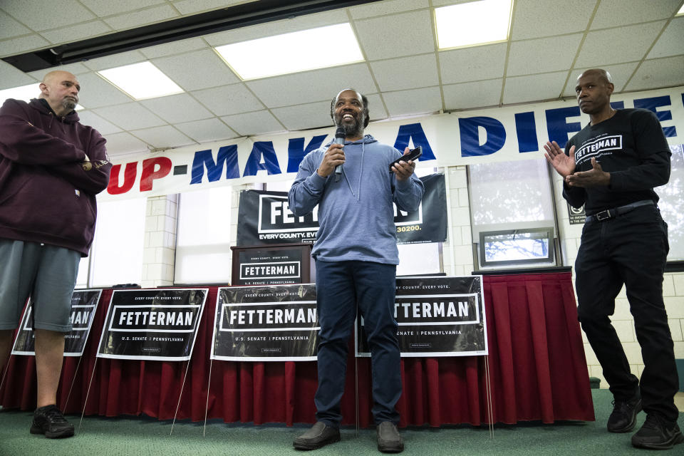 Democratic candidate for U.S. Senate, Lt. Gov. John Fetterman of Pennsylvania, left, and Dennis Horton, right, listen to Lee Horton speak during a rally at the UFCW Local 1776 KS headquarters in Plymouth Meeting, Pa., on April 16. (Tom Williams / CQ Roll Call via AP file)