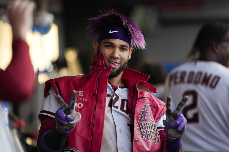 Arizona Diamondbacks designated hitter Lourdes Gurriel Jr. (12) celebrates in the dugout after hitting a grand slam during the second inning of a baseball game against the Los Angeles Angels in Anaheim, Calif., Friday, June 30, 2023. Jake McCarthy, Geraldo Perdomo, and Ketel Marte also scored. (AP Photo/Ashley Landis)