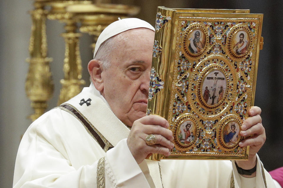 Pope Francis holds up the book of Gospels as he celebrates an Epiphany Mass in St. Peter's Basilica at the Vatican, Monday, Jan. 6, 2020. (AP Photo/Andrew Medichini)