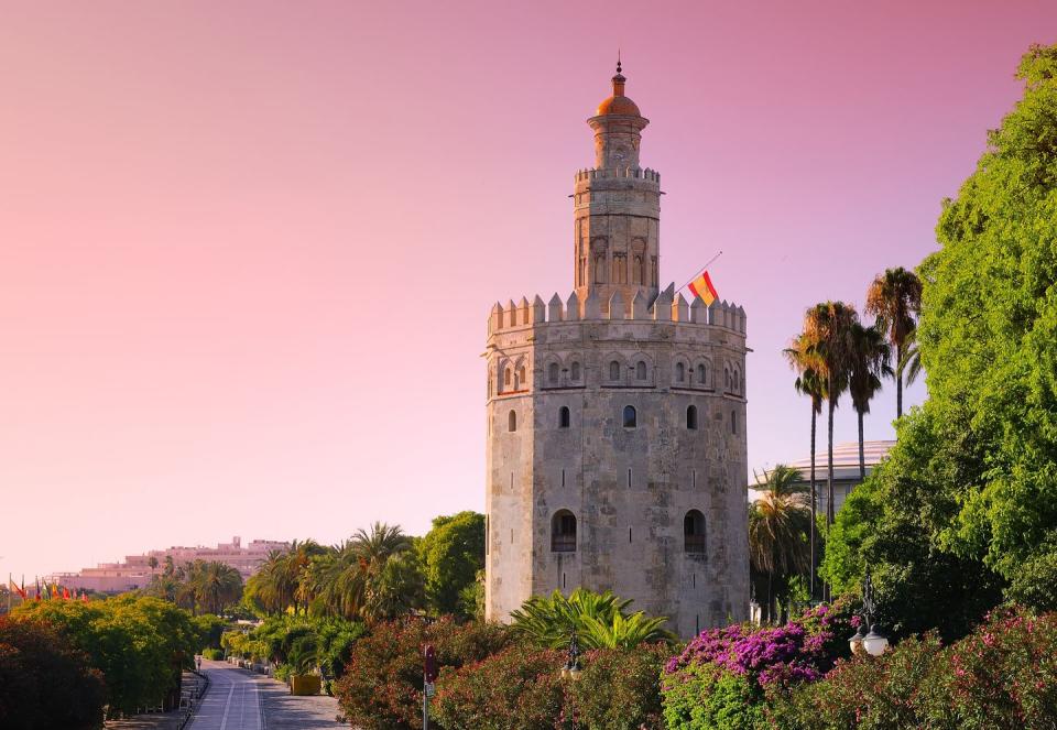 gold tower at sunrise in seville, spain