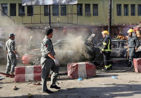 Afghan policemen inspect the site of a blast in Jalalabad city, Afghanistan, July 1, 2018. REUTERS/Parwiz