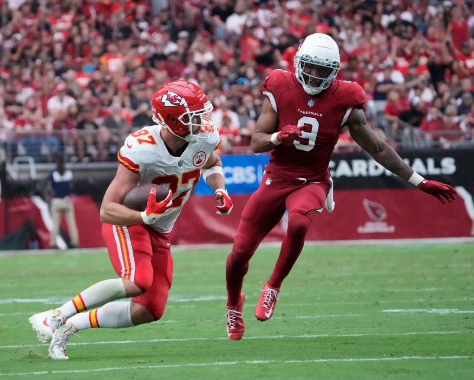 Sep 11, 2022; Glendale, Arizona, United States;  Kansas City Chiefs tight end Travis Kelce (87) runs past Arizona Cardinals linebacker Isaiah Simmons (9) during the third quarter at State Farm Stadium.