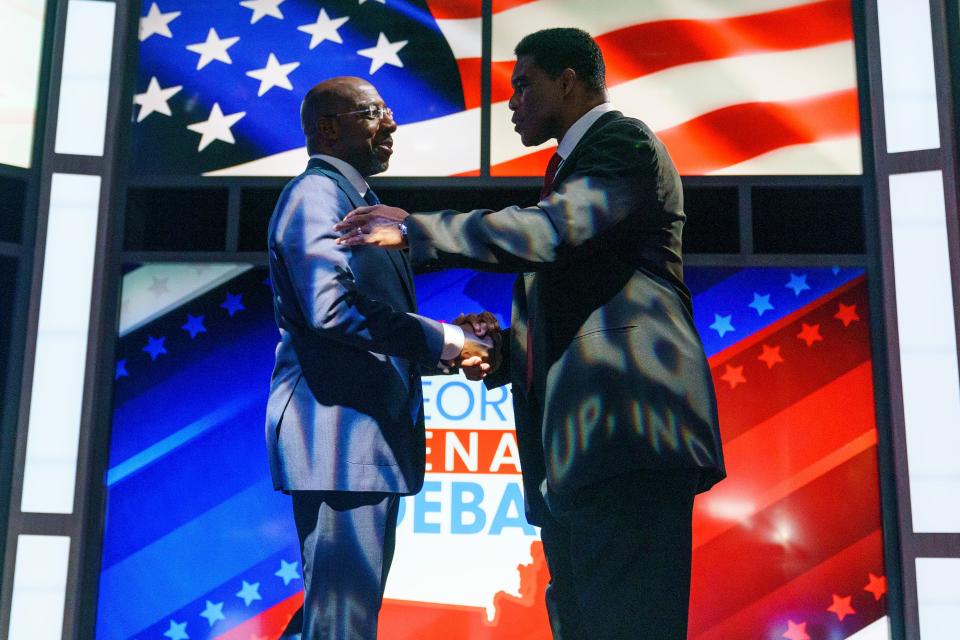 Sen. Raphael Warnock (D-Ga.) shakes hands with Republican candidate Herschel Walker prior to the Nexstar Georgia Senate Debate at District Live at Plant Riverside District in Savannah, Ga., on Friday, October 14, 2022.