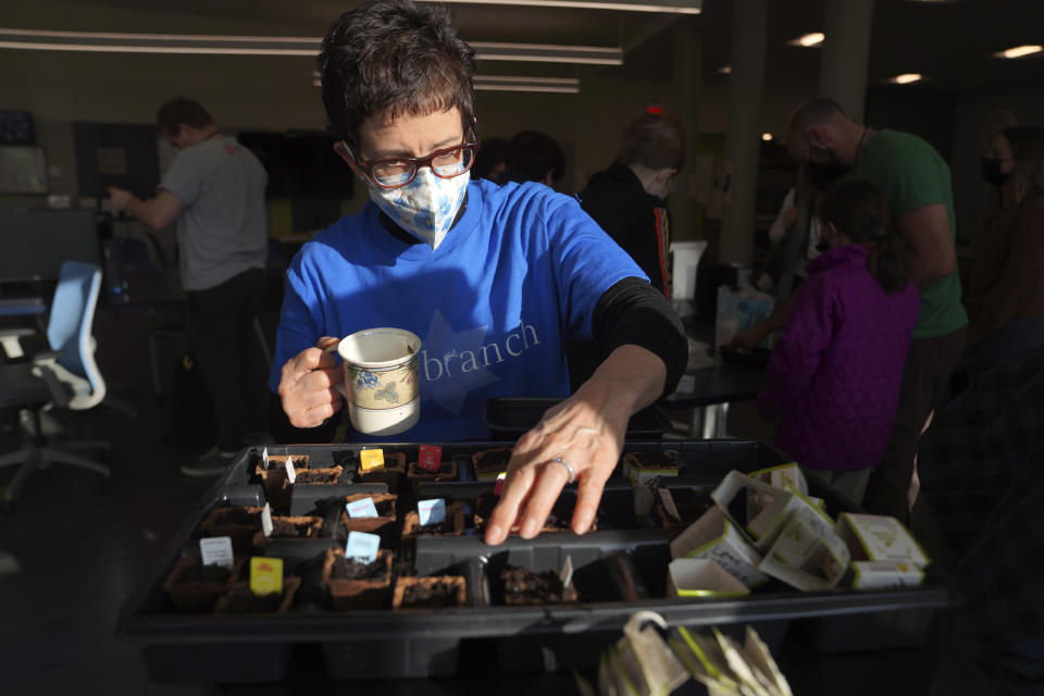 Nancy Gale, executive director of The Branch, an organization that supports people with psychiatric, developmental or intellectual disabilities, plants seeds during the Community Gardening Program, Chai Chai V'kayam, or "live, live and be sustained," hosted by Repair the World Pittsburgh and the 10.27 Healing Partnership, on Tuesday, April 18, 2023, in Pittsburgh, Pa. The series of service-learning programs is focused on sustaining and supporting individuals, the community, and the earth, during difficult times, such as the upcoming federal trial for the suspect in the Pittsburgh synagogue massacre that took place on Oct. 27, 2018. (AP Photo/Jessie Wardarski)